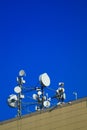 Cellular aerials against the vivid blue sky. Microwave transmission tower