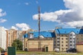 Cellular antenna against a blue cloudy sky in a residential residential area. Modern communication technologies Royalty Free Stock Photo