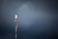 Cellular antenna on background of a dark stormy sky. Signal rec Royalty Free Stock Photo