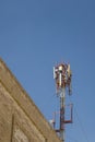 Cellular antenna. Communication on a building roof top Royalty Free Stock Photo