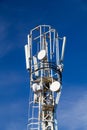 Cellular antennas on the top of the mast, close-up on a background of blue sky