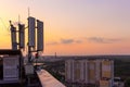 Cellular communications tower on a background of the city and a beautiful sunset in summer Royalty Free Stock Photo