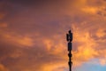 Cellular communications tower on vivid dramatic clouds background in evening, copy space Royalty Free Stock Photo