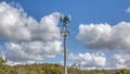 Cellular, mobile phone transmitter tower with blue sky and clouds middle Royalty Free Stock Photo