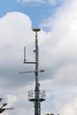 Cellular, mobile phone transmitter tower and weather station Royalty Free Stock Photo