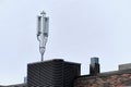 Cellular phone network telecommunication tower on the building roof Royalty Free Stock Photo