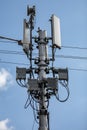 Cellular signal repeater under a blue cloudy sky