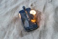 cellular telephone. on the beach sand. it has a metal nail in it. it burns with open fire Royalty Free Stock Photo