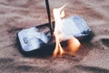 cellular telephone. on the beach sand. it has a metal nail in it. it burns with open fire Royalty Free Stock Photo