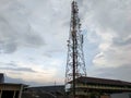 Cellular tower in the middle of civilian homes under the gloomy weather