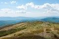 Cellular tower in the mountains. Mountain landscape on a sunny day. Destroyed building in the mountains. Royalty Free Stock Photo