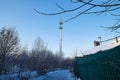 Cellular tower in village on winter sunny day or evening and blue sky background Royalty Free Stock Photo