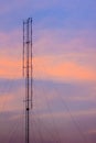 Cellular transmitter, folded dipole radio antenna for telecommunications with colorful sky background. Silhouette amateur radio Royalty Free Stock Photo