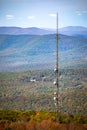 Cellular transmitting tower mounter in the forst hill at fall Royalty Free Stock Photo
