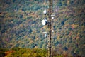 Cellular transmitting tower mounter in the forst hill at fall Royalty Free Stock Photo