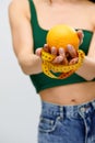 Cellulite is consequence of poor nutrition. Nutritionist holding measuring tape with orange fruit, panorama Royalty Free Stock Photo