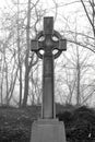 Celtic Cross in very foggy graveyard