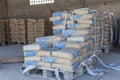 Cement bags in a row on the Palace in the shed.