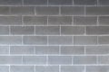 A cement concrete grey brick wall backdrop with symmetrical lines