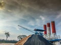 Cement concrete mixing production factory with dramatic sky background. Concrete batching plant at construction site Royalty Free Stock Photo