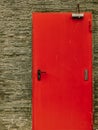 Cement concrete wall texture with modern red door. Royalty Free Stock Photo