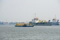 Cement container ship sails pass sand digger ships in Chao Phraya river Royalty Free Stock Photo