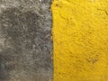 Cement floor texture half painted yellow. Yellow and gray rough texture. Bi-color geometric abstract background Royalty Free Stock Photo