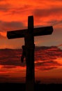 Cement life size cross with body of Jesus as sun sets