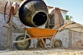 Cement making for construction job, with cement mill machine and wheelbarrow Royalty Free Stock Photo