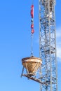 Cement Mixer Being Held Aloft by a Crane