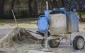 Cement mixer machine at construction site, tools and sand Royalty Free Stock Photo