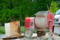 Cement mixer machine at construction site, tools and sand Royalty Free Stock Photo