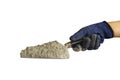 Cement or cement powder on the plastering trowel, including the hands of the builder isolated on white background.