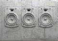 Cement sculpture in the shape of a sound speaker on a concrete facade wall. 3D wall panel of audio system. Creative conceptual