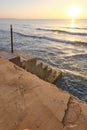 Cement stairs going down directly to the beach water from the homes Royalty Free Stock Photo