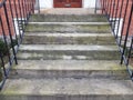 Cement stairs with metal railing and red brick building Royalty Free Stock Photo