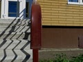 Cement stairs up. Sun shade. Burgundy metal railing Royalty Free Stock Photo