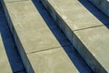 Cement steps with visible shadows as background design in late afternoon sun in city for texture image Royalty Free Stock Photo