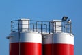 Detail of steel cement storage silos in red and white. construction concept.