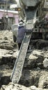 Cement truck pour fluid concrete into foundation pit piles. Female worker working in site