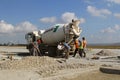 Cement truck pouring cement into a runway construction