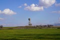 Cement water storage tank in a green grain field Royalty Free Stock Photo