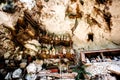 The cemetery with coffins placed in cave and balconies with wooden statues tau tau. Old burial site in Londa, Tanaja, Indonesia