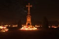 Cemetery - cross lit by candle lights Royalty Free Stock Photo