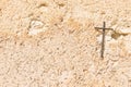 Christian cross on light brown wall background