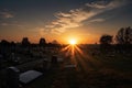 cemetery at dusk, with the sun setting over the horizon and a clear sky