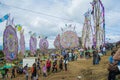 cemetery with giant colorful kites made of paper with many people