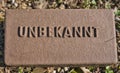 Cemetery grave marker for unknown person with german letters UNBEKANNT Royalty Free Stock Photo