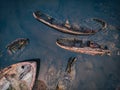 Cemetery of old ships Teriberka Murmansk Russia, wooden remains of industrial fishing boats in sea. Industrialization