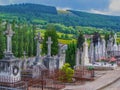 Cemetery Rolling Hills Landscape in Belgium Europe with brightly colored yellow fields and forest in Background